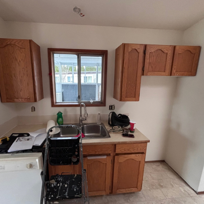 Kitchen with wooden cabinets before being remodeled and updated.